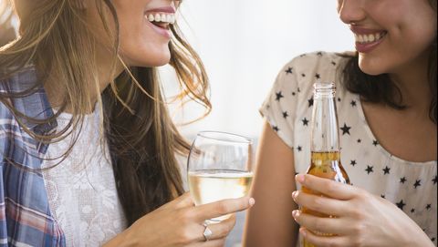 Hispanic women drinking beer and wine together
