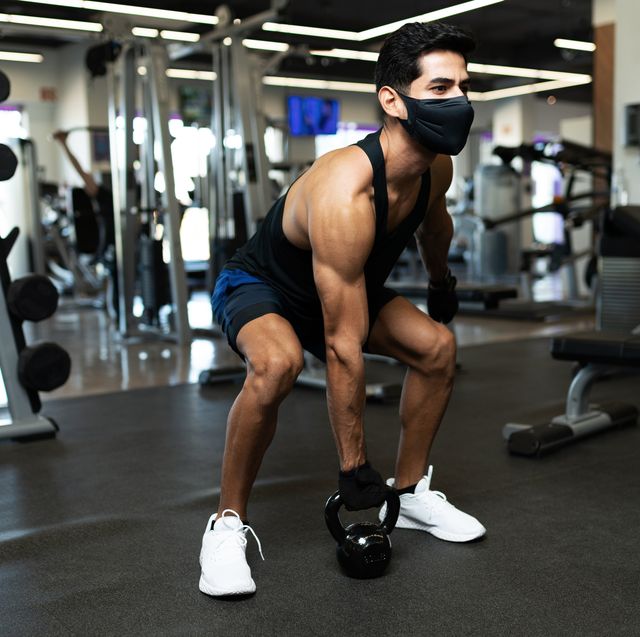 hispanic young man training with a dumbbell