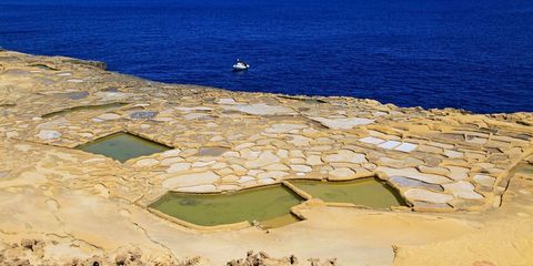 Historic ancient salt pans on coast near Marsalforn, island of Gozo, Malta
