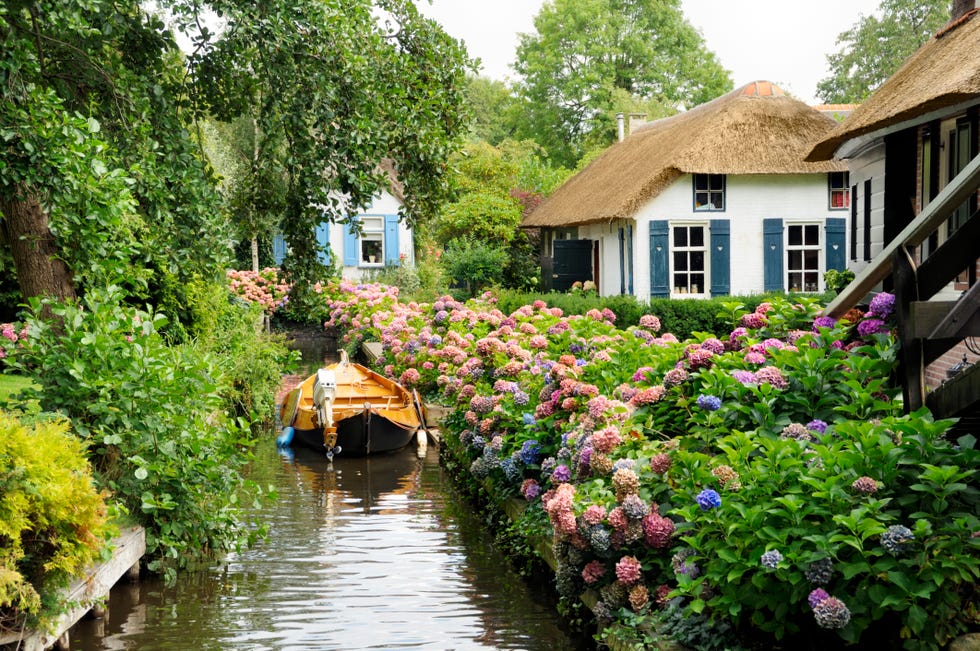 Photo of a cottage by a river