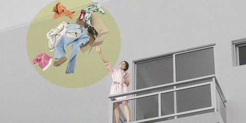 Mixed race woman throwing clothes off balcony