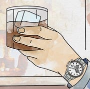 hand holding whiskey wearing hodinkee watch