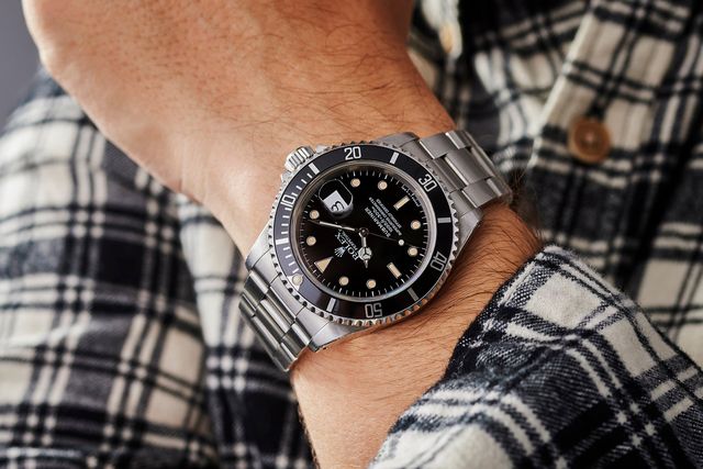 man wearing a rolex on his wrist