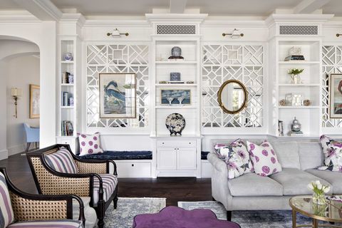 living room, gray sofa, purple and white decorative cushions, white storage cabinets, purple ottoman