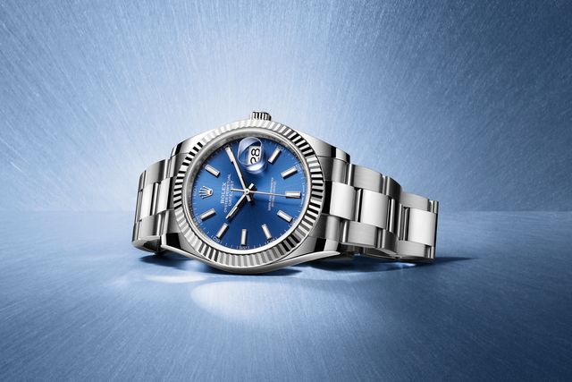 rolex with blue watch face on a blue background