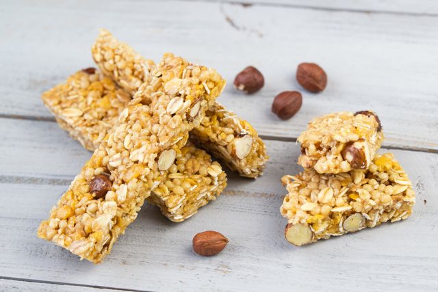 homemade granola bars with roasted nuts, selective focus, wooden background