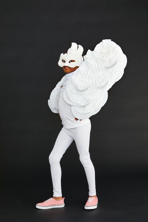 homemade halloween costumes, small girl wearing a white shirt, white leggings, a white mask and diy white wings