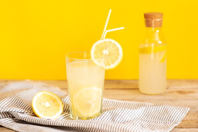 homemade lemonade in mason jars with big green paper straw