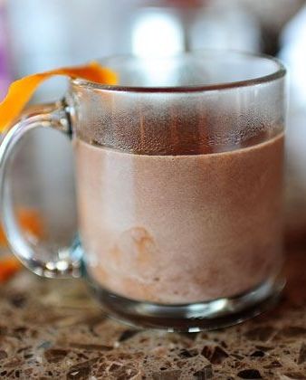 delicious hot chocolate in glass mug with orange peel