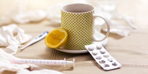 Hot tea for colds, pills  handkerchiefs and thermometer