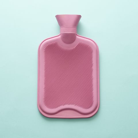 pink hot water bottle on blue background