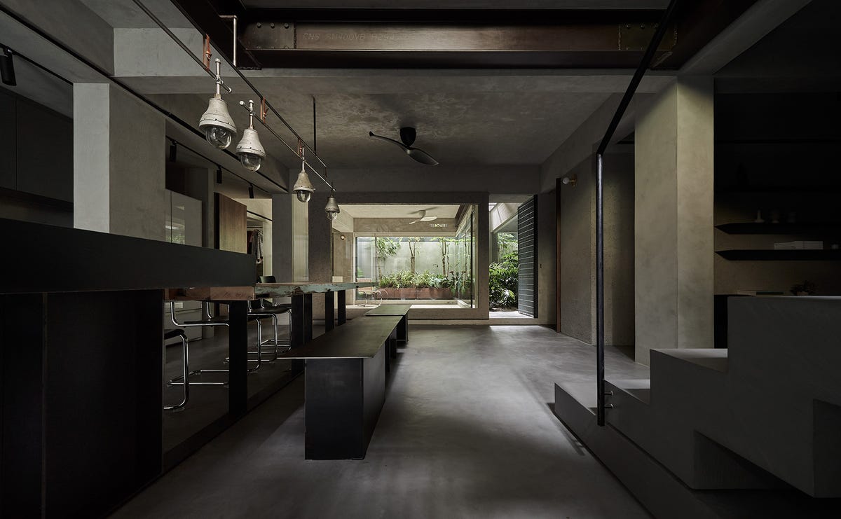 Una casa de estilo industrial con un patio interior en el sótano