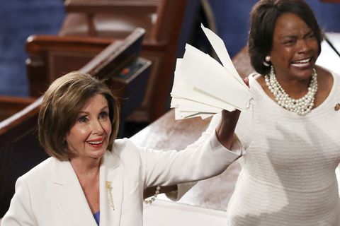 House Speaker Rep. Nancy Pelosi (D-CA) (L)  holds up the ripped up copy of President Donald Trump's speech after the State o