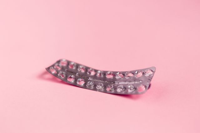 how long does it take for the pill to work an empty strip of birth control pills on pink background
