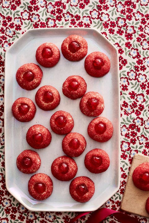 red cherry thumbprint cookies on white plate