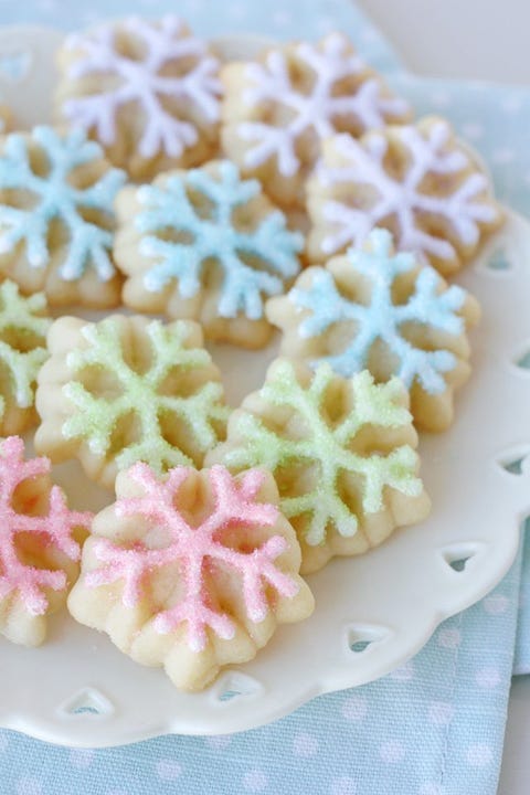 christmas cookie decorating with snowflakes in pastel frosting