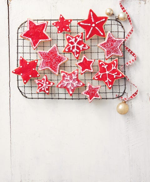 christmas cookie decorating with red sugar cookie stars on wire rack