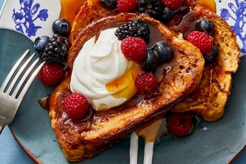 french toast topped with fresh berries, yogurt and maple syrup