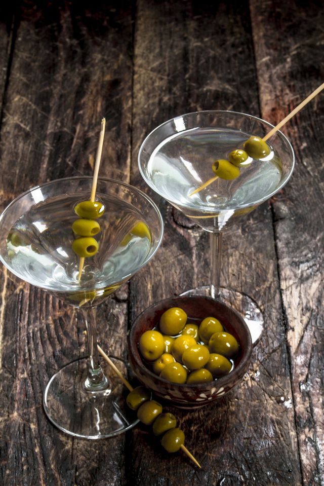 martini with olives on a wooden background