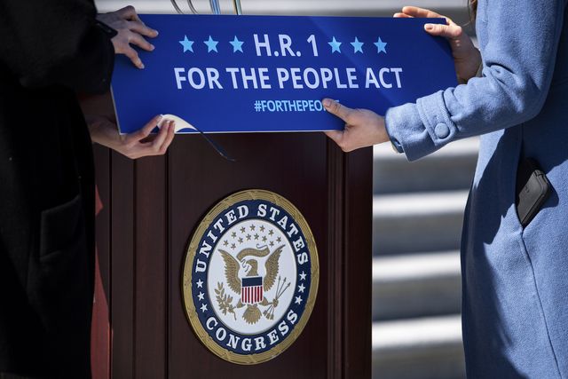 united states   march 3 staffers place a sign on a podium in preparation for a news conference with house democrats regarding hr 1, the for the people act, in washington on wednesday, march 3, 2021 photo by caroline brehmancq roll call, inc via getty images