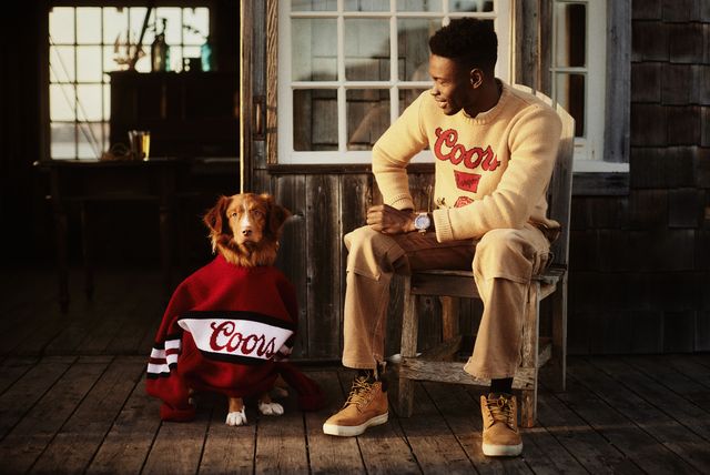 huckberry man wearing coors sweater sitting next to dog wearing a coors sweater