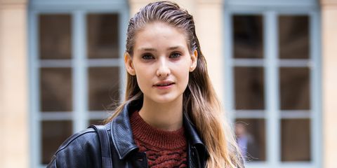paris, france   march 03 a model, wearing a brown sweater, jeans, black leather jacket and black bag, is seen outside valentin yudashkin, during paris fashion week   womenswear fallwinter 20202021  day nine on march 03, 2020 in paris, france photo by claudio laveniagetty images