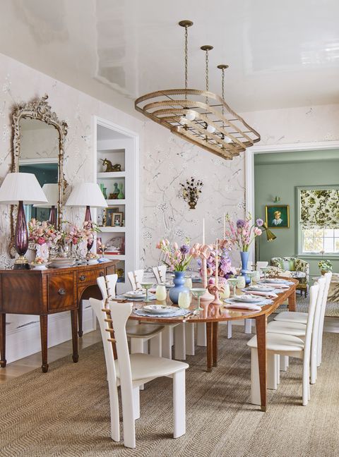 in the dining room the tiered brass chandelier crowns a custom fruitwood table by the ceh