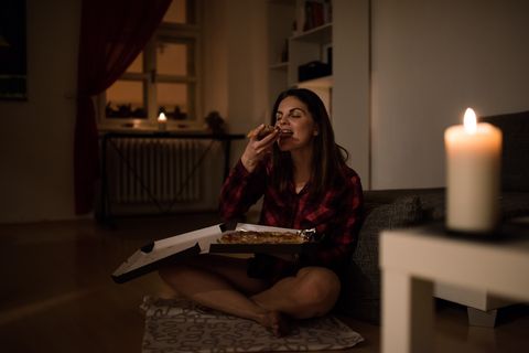 hungry woman having a slice of pizza