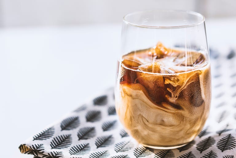 Iced latte on leaf patterned tea towel