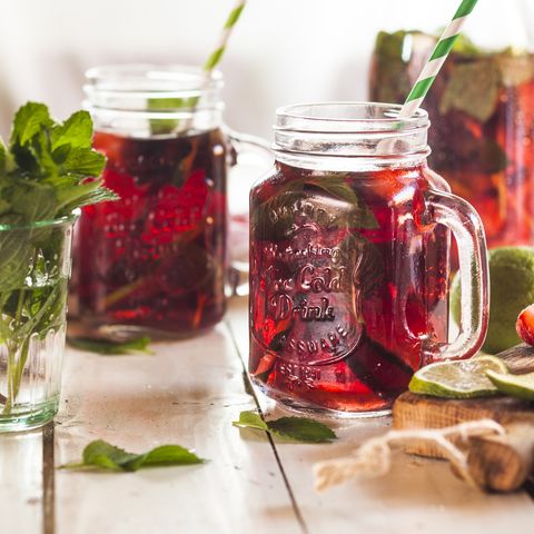 iced tea with fruits, hibiscus, strawberries, mint, limes