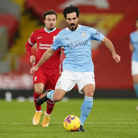 Manchester City's ilkay guendogan runs with the ball during a premier league football game against liverpool