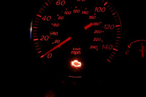 Illuminated check engine light displayed on a vehicle dashboard