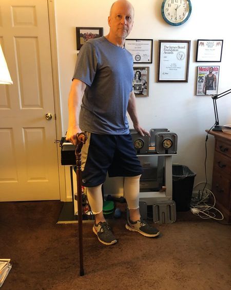 man with cane in home gym