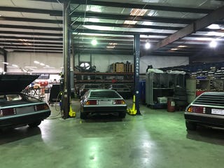 Car, Vehicle, Automobile repair shop, Delorean dmc-12, Building, Executive car, Classic car, Sedan, Coupé, Metal,