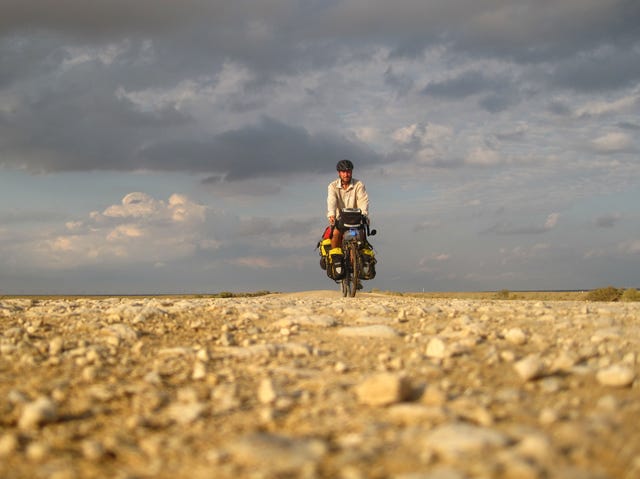 Noel riding his bike during his epic cross country journey