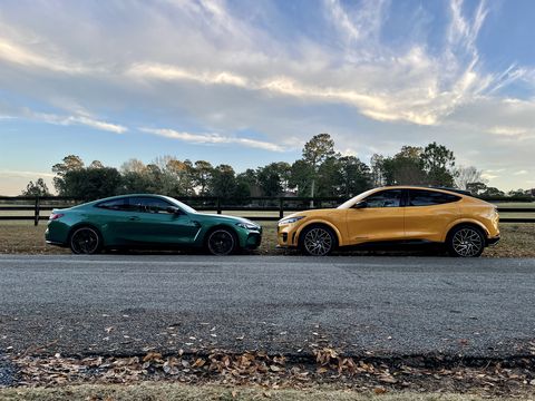 2021 ford mustang mach e and 2022 bmw m4 competition parked nose to nose