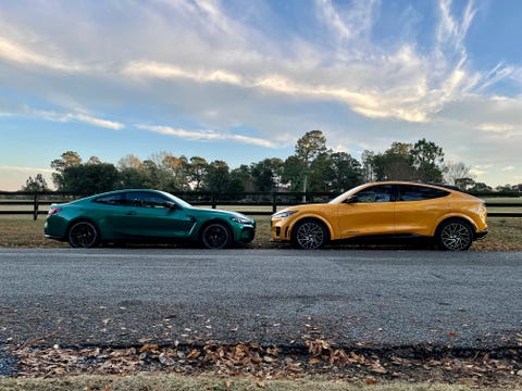 2021 ford mustang mach e and 2022 bmw m4 competition parked nose to nose