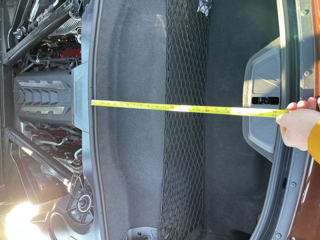meauring the trunk of the c8 corvette with a tape measure