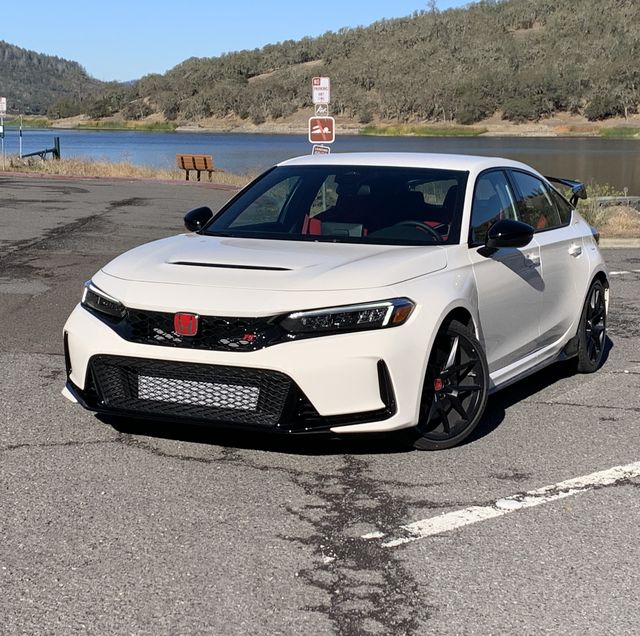 honda civic type r parked in front of a lake