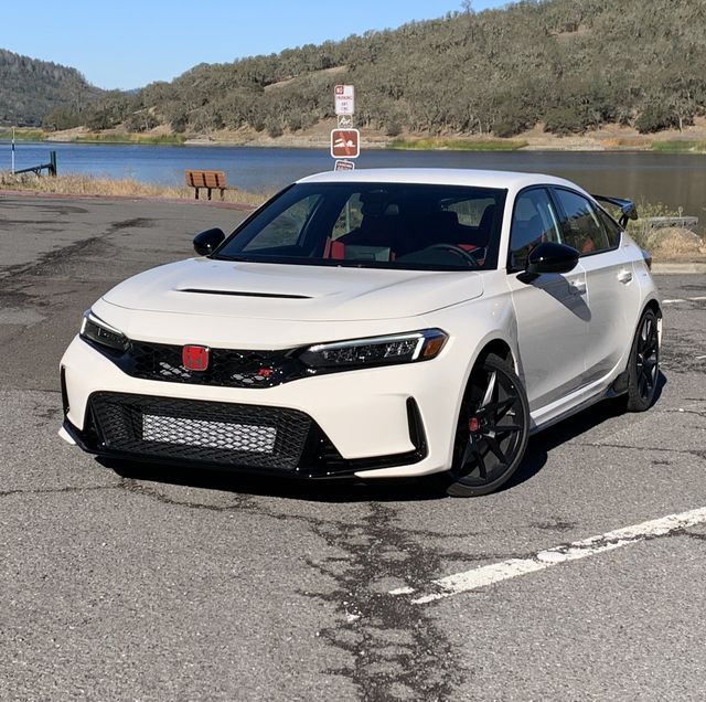 honda civic type r parked in front of a lake