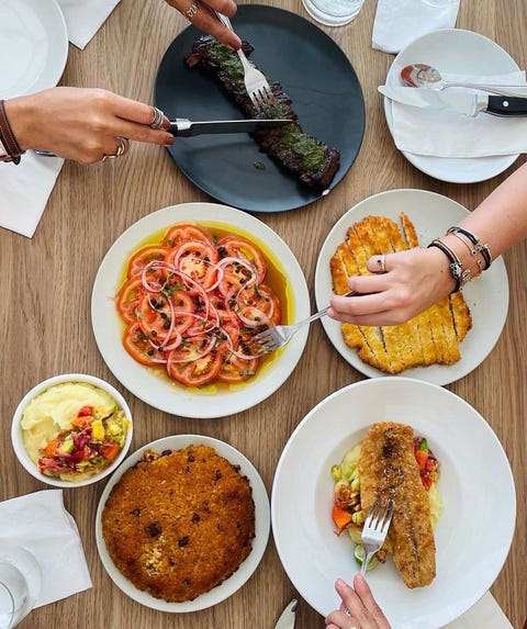 table filled with food from jose enrique restaurant