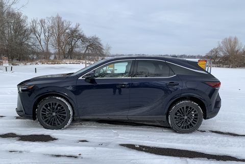 lexus rx 350h from the side next to a snowy boat launch