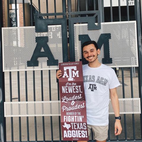 tyler cruz posing with a texas a and m sign
