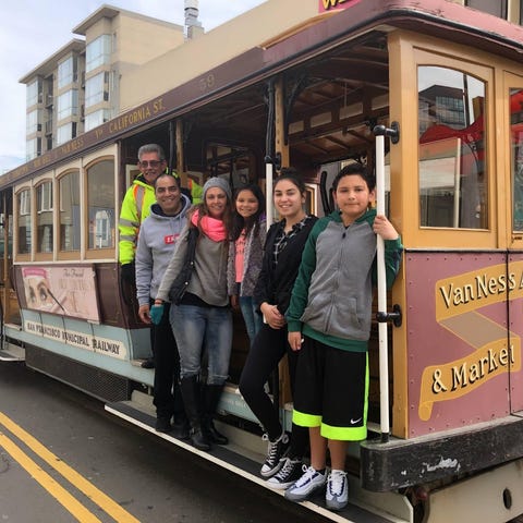 family riding a cable car