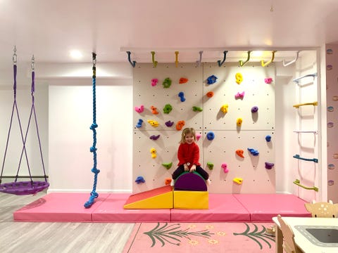 a rock climbing wall and monkey bars by smart d2 playrooms in parker bowie larson's home