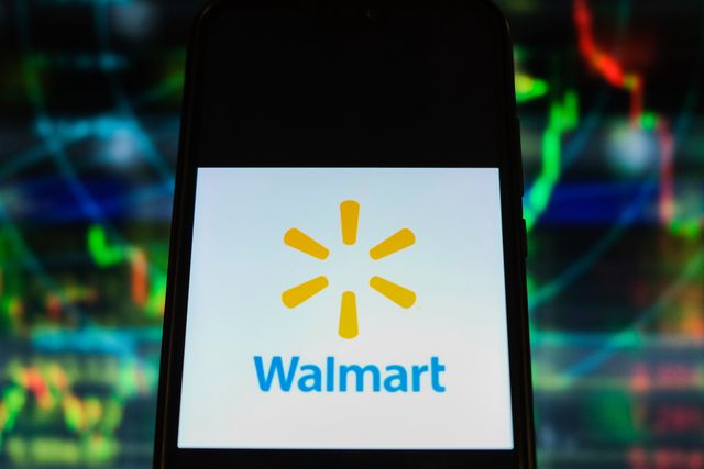 in this photo illustration a walmart logo is displayed on a