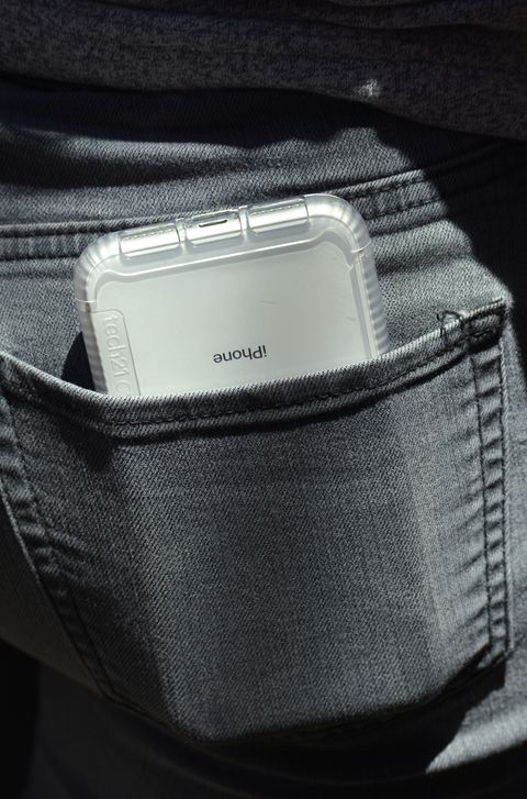 A teenager carries her iPhone in her back pocket
