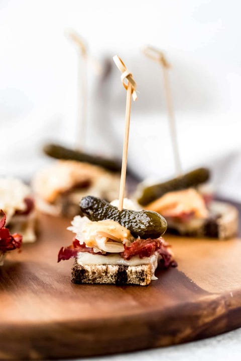 mini reubens on wood board with toothpick