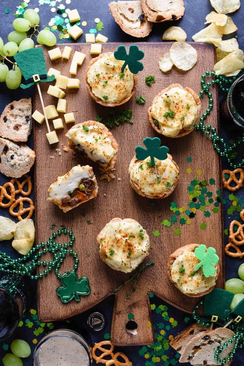 mini shepherds pie on wood board with st patricks day decorations