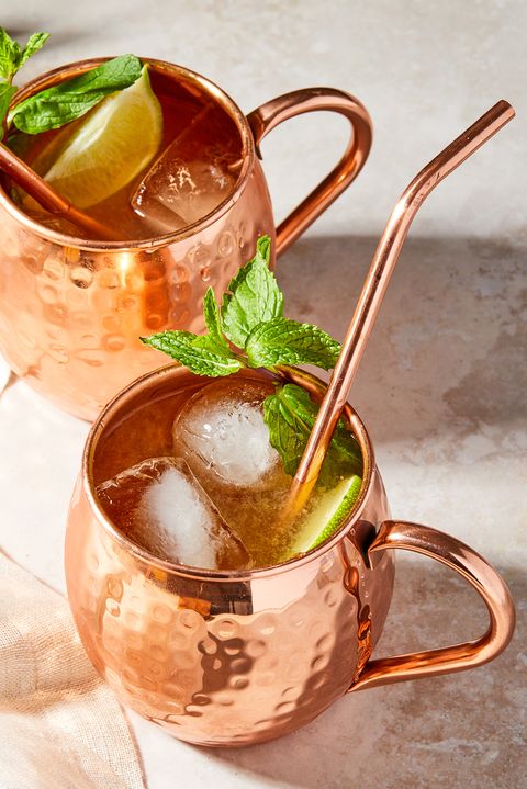 two irish mules garnished with mint in copper mugs